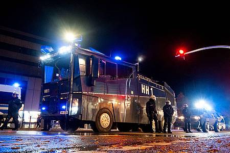 Ein Wasserwerfer der Polizei steht im Stadtteil Harburg bereit. In der Halloween-Nacht ist es in Hamburg zu Ausschreitungen gekommen.